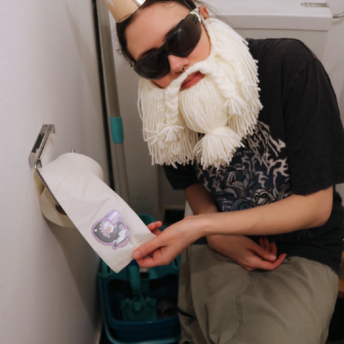 Sticker “ADHD - All Ducks Have Demons” held by the Crafting Wizard sitting on a toilet, pulling the toilet paper roll beside him in a funny staged scene.