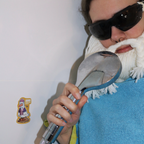 Sticker “ADHD - All Ducks Have Diarrhea” in a shower scene with the Crafting Wizard in a towel holding the shower head like a microphone, sticker on the wall in a funny staged setup.