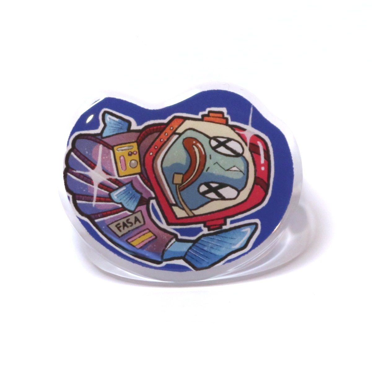 Acrylic pin of an astronaut fish floating upside down in space, wearing a cracked helmet and spacesuit, giving a lifeless, eerie look.