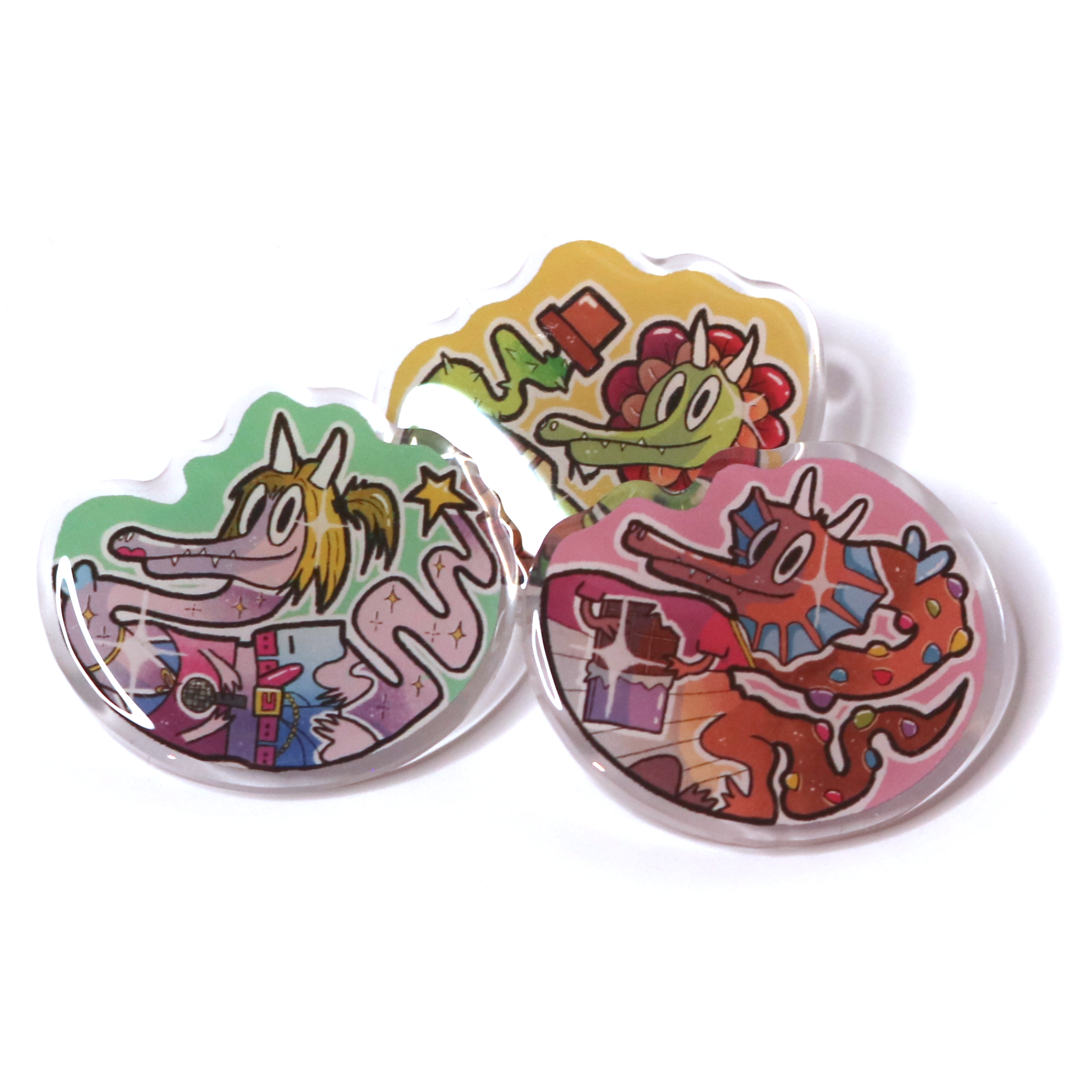 Acrylic pin set of all crafting wizard dragon designs displayed together on a white background, showing three cute stylized dragon acrylic pins.