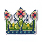 Cross-stitch fairy crown in green, blue, yellow, and pink with floral details.