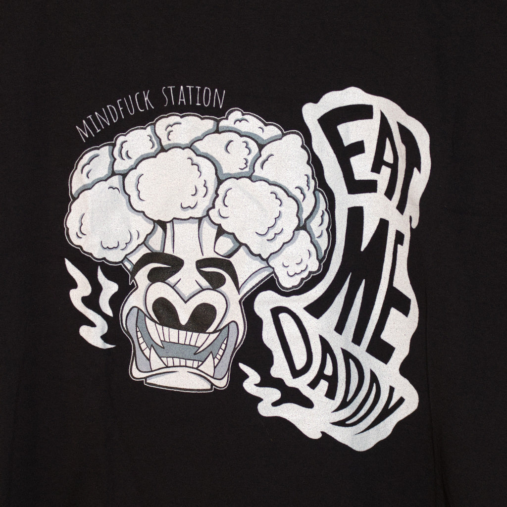 Close-up of the broccoli graphic and Eat Me Daddy lettering on the black T-shirt