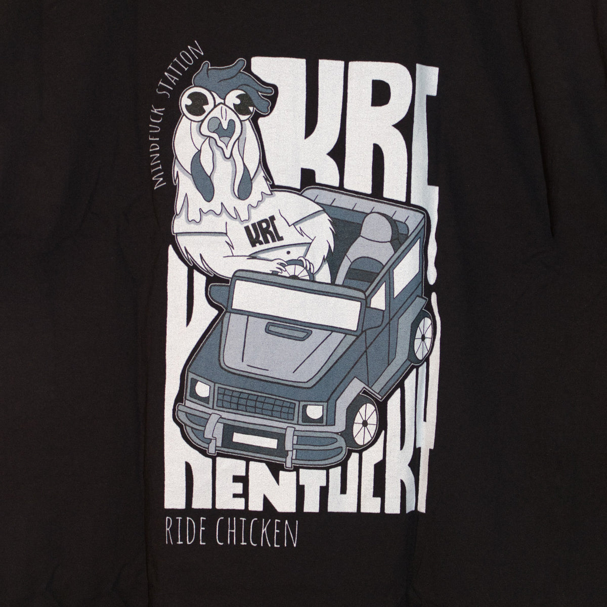 Close-up of the chicken and car graphic on the back of the Ride Chicken T-shirt