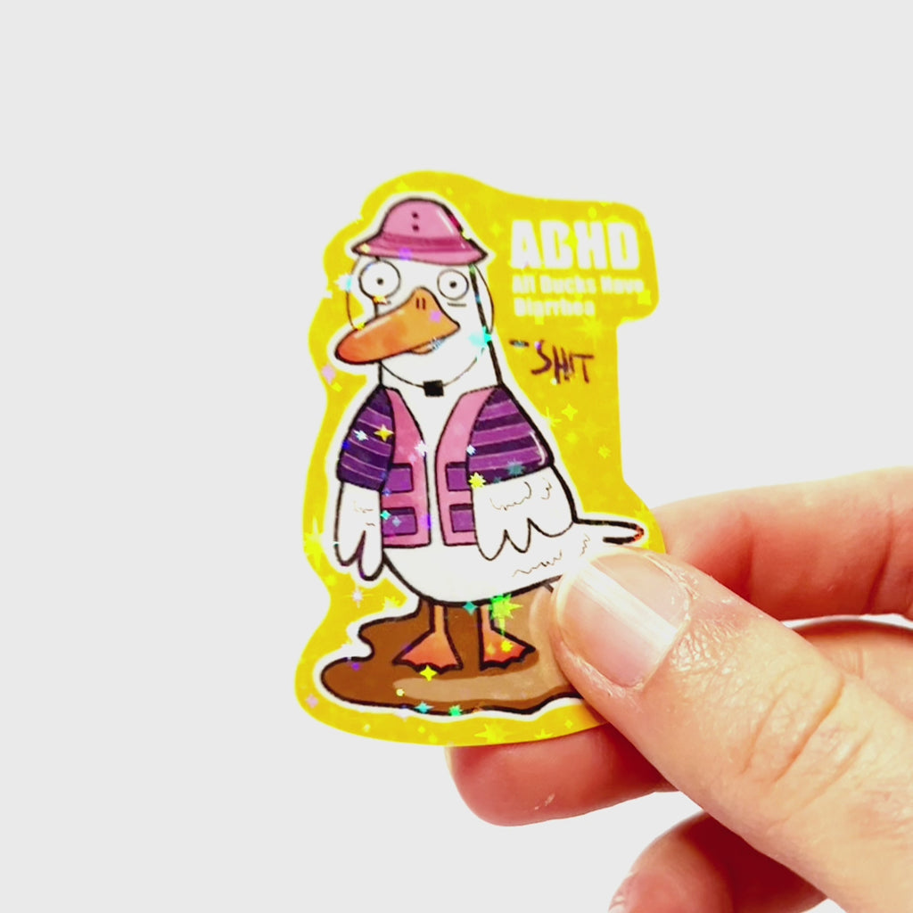 Video: Sticker of a cartoon duck wearing a fishing hat and vest, standing in a puddle, with the slogan ‘ADHD – All Ducks Have Diarrhea.’